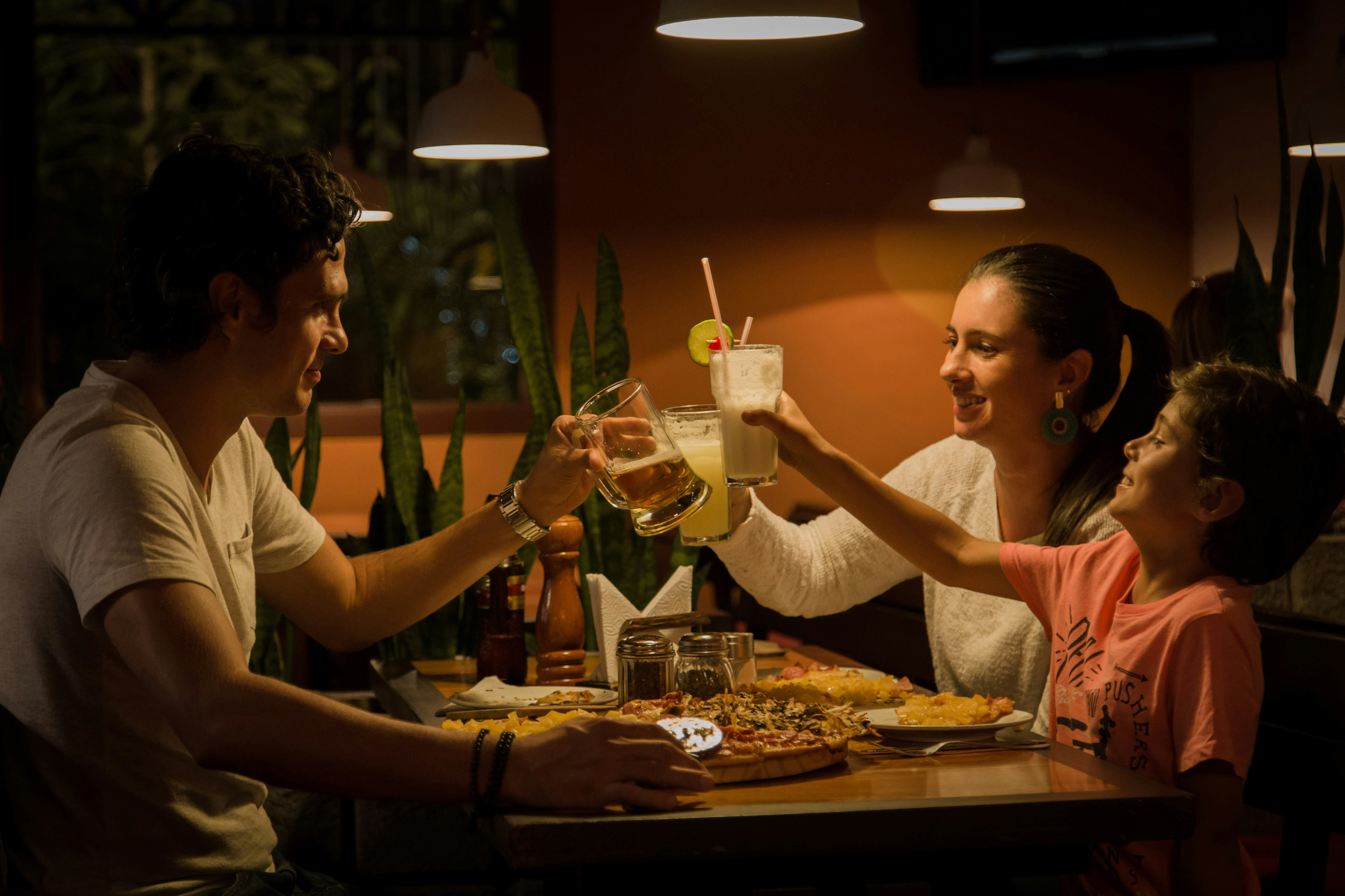 Family having dinner and toasting with drinks