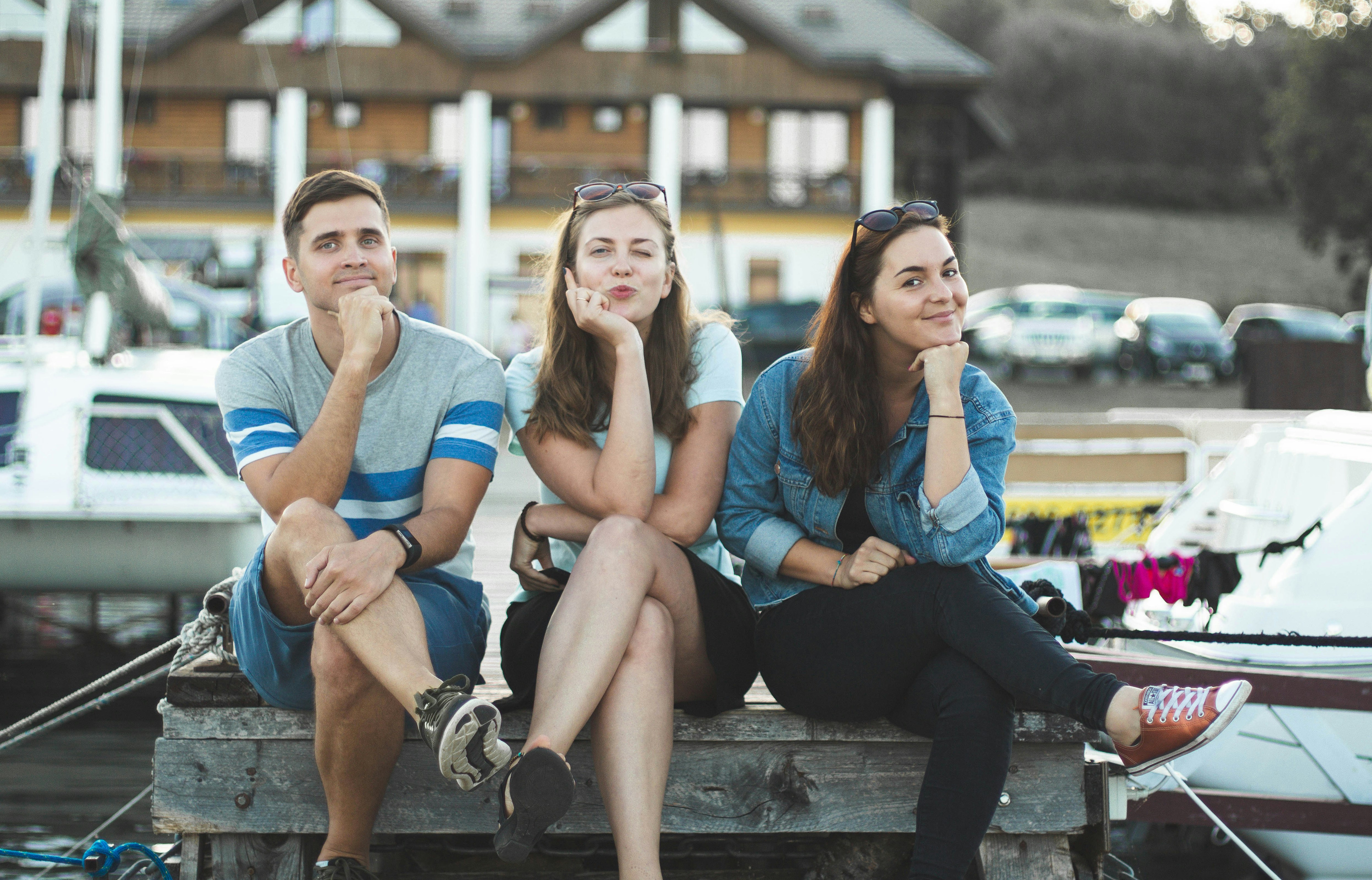 Three friends sitting together in thoughtful poses